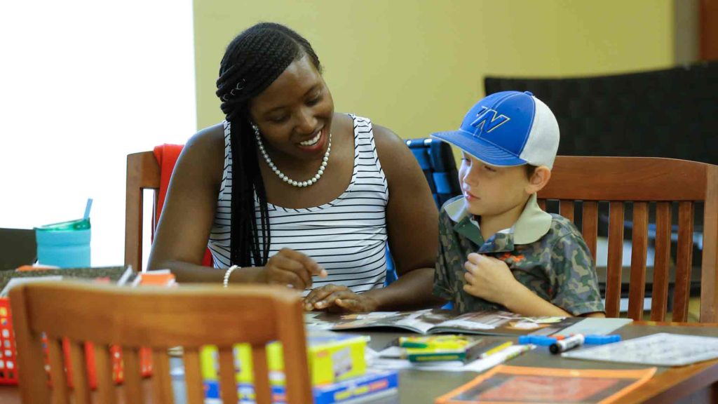 Student teaching an elementary school student how to read