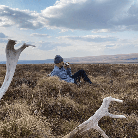 man relaxes in the Alaskan Western Arctic