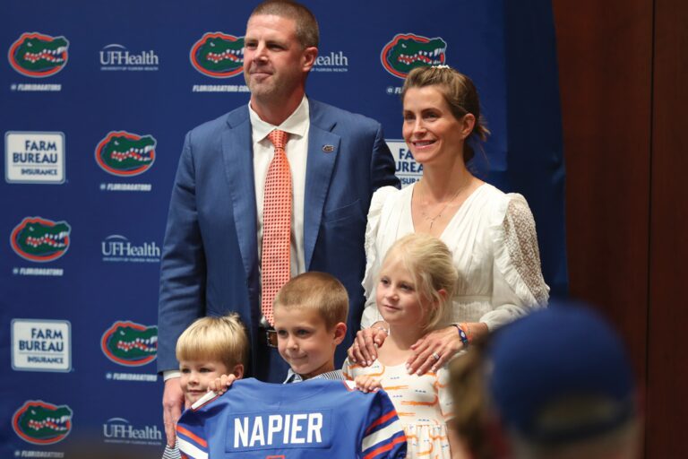 Billy Napier and family take a picture with a Florida Gators jersey