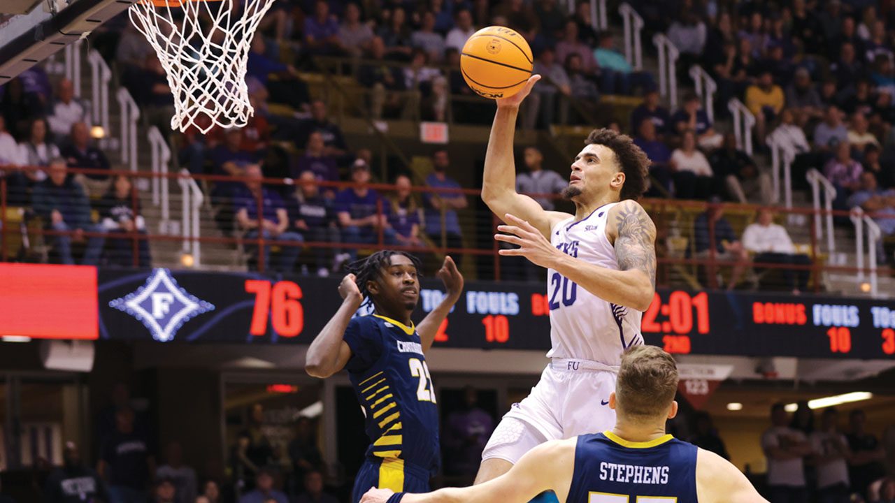 Southern Conference Player of the Year Jalen Slawson ’23 elevates for a late second-half jam that helps power Furman to its 88-79 tournament title game victory over Chattanooga at Harrah’s Cherokee Center in Asheville, North Carolina, on March 6. / Jeremy Fleming
