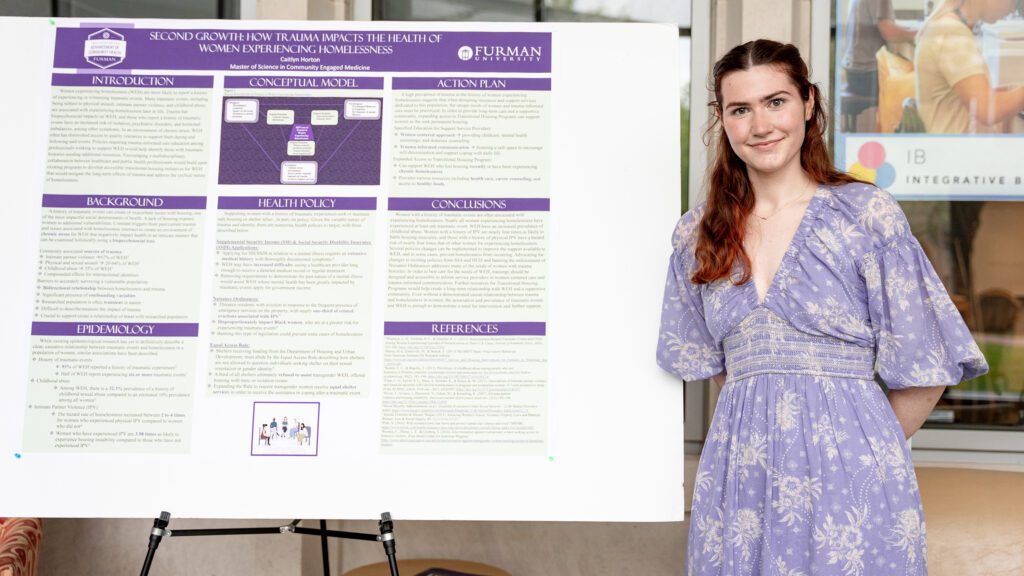 Woman stands with poster