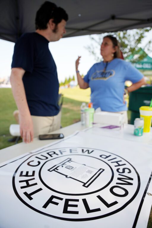 Furman alum Charles Hedgepath talks with Eileen Shell, an employee of Mental Health America of South Carolina during The Marcus King Family Reunion at CCNB Amphitheatre at Heritage Park