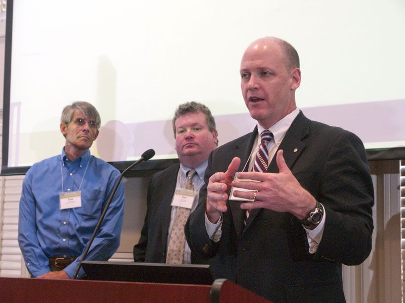 The Gladiators: Ed Memmott speaking; (l-r) Tom Praktish and Ken Tuck