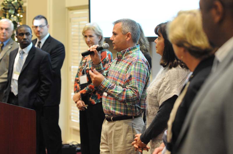 Beyond the Classroom: (l-r) Larry Bagwell, James Jordon, Cindy Cambron, Bianca Walker, Brian Barron (speaking), Janet Wade, Becky Faulkner and Chris Smith