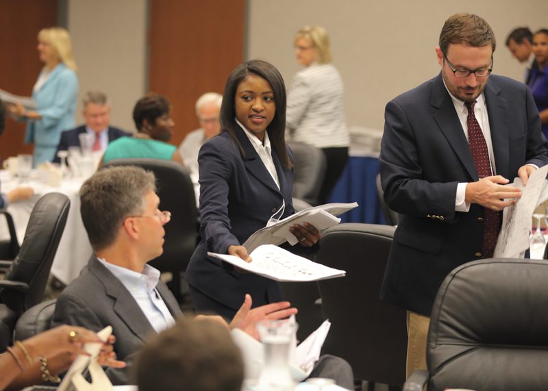 Katrina Goggins and other members of The A Team pass out copies of the diversity activity book they created.