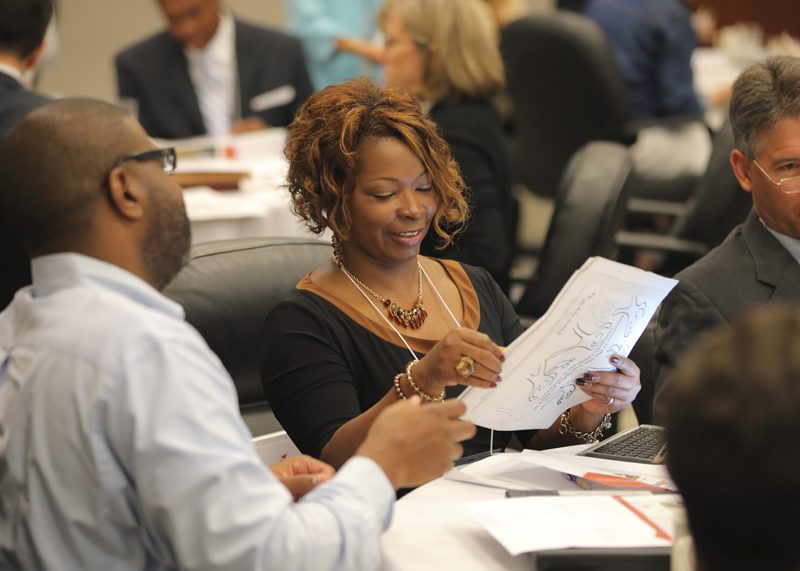 Trevea Martin admires the diversity activity book presented by The A Team.