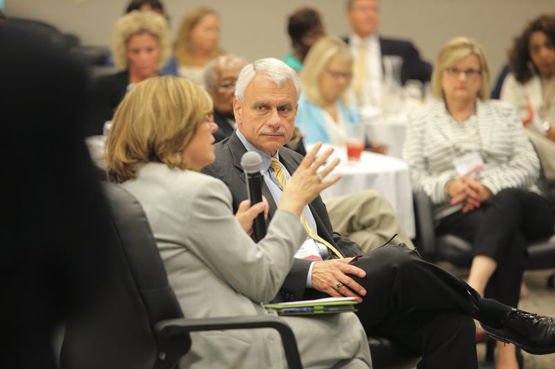 Jennie Rakestraw speaking with Rick Mendoza looking on.