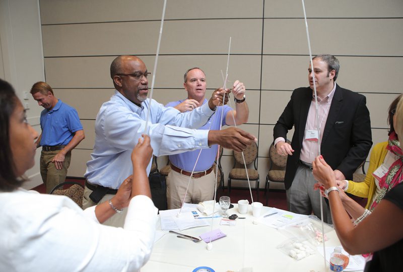 The STEM Stars team builds a tower in the activity.