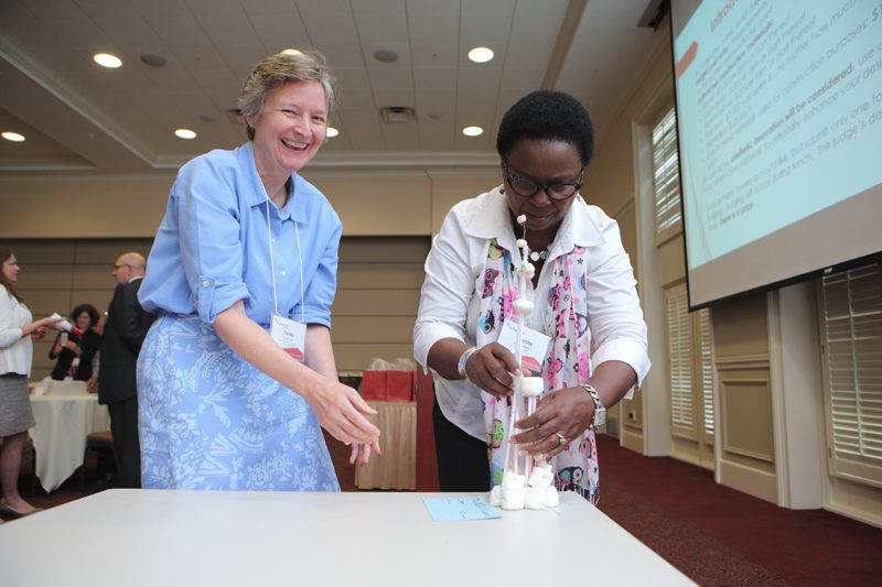 Tandy Taylor and Yvonne Reeder submit the Bike Hubbers' tower for judging in the STEM activity.