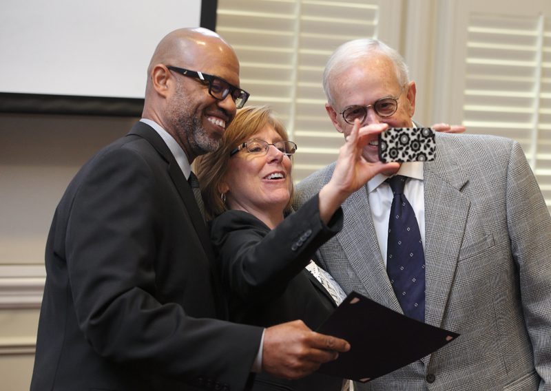 Juan Johnson, Nancy Halverson and Calder Ehrmann take selfies.