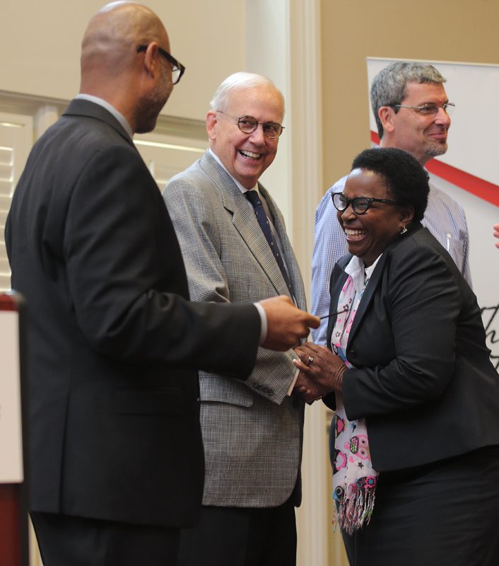 Yvonne Reeder receives congratulations from Juan Johnson and Calder Ehrmann.