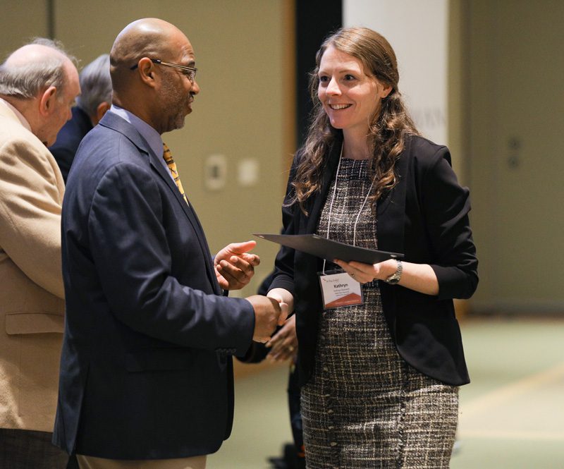 Kathryn Diminich, Wake Up Carolina, receiving her Riley Fellow certificate from Juan Johnson