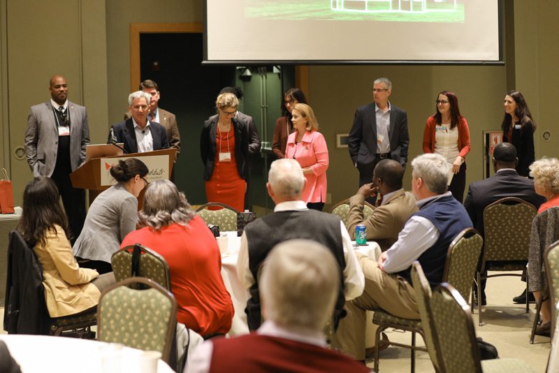 Team Leverage: (l-r) Anton Gunn, Brent Jonas, Sally Newman, Nancy Zisk, Susan Gaddy, Don Pratt, guests and Loren Ziff speaking