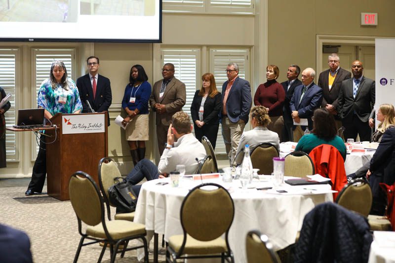 PW Chop: (l-r) Amy Mundt speaking, Matt Bitner, Altheia Richardson, Rich Hagins, Carol Samofal, Walt Gregory, Kirsten Small, Jim Dant, Lee Tennent, Burke Royster, Marcus Davenport