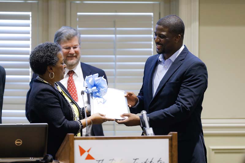 Darian Blue, Riley Fellow, Upstate Class XVIII Fall 2014, receiving a gift from Thessa Smith, Calder Ehrmann Culinary Program at PW