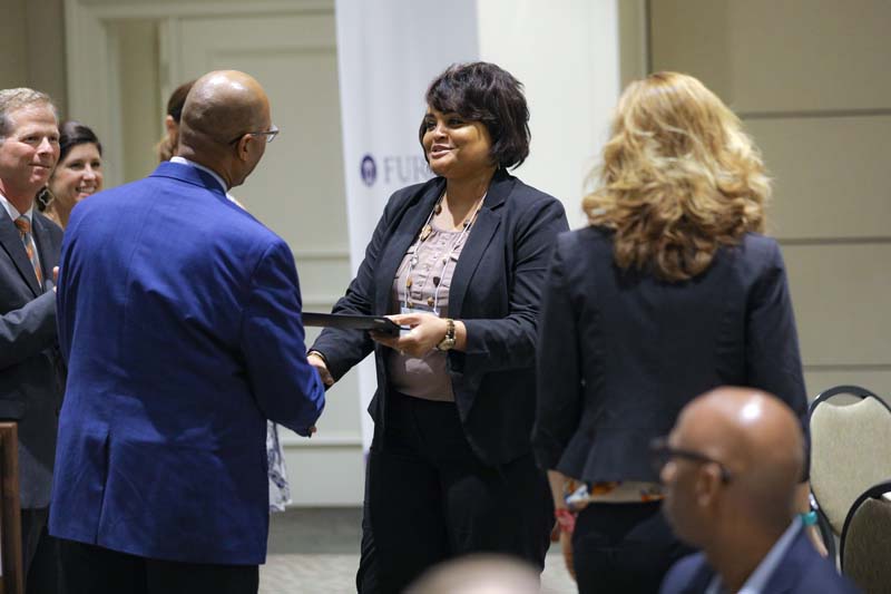 Ivory Mathews, Freshmen to Finish, receiving her Riley Fellow certificate from Juan Johnson