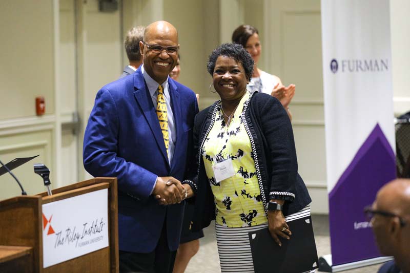 Thessa Smith, Calder Ehrmann Culinary Program at PW, receiving her Riley Fellow certificate from Juan Johnson