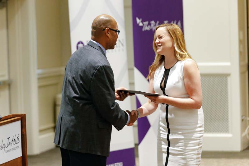 Meghan Barp, Book Bags of Love, receiving her Riley Fellow certificate from Juan Johnson