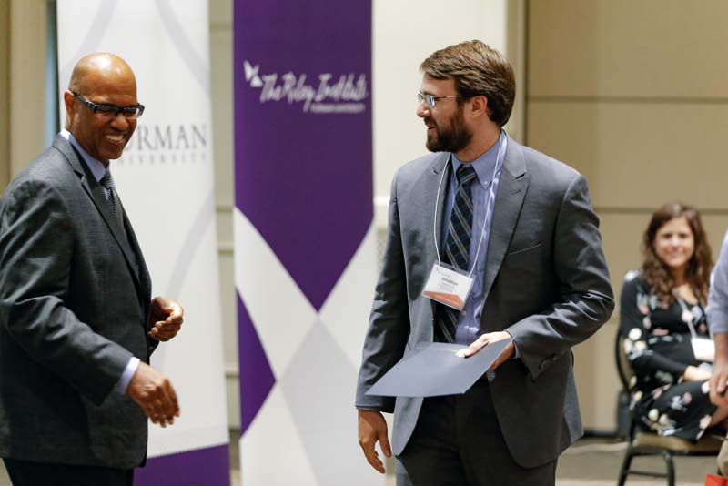 Jonathan Cote, SAFER, receiving his Riley Fellow certificate from Juan Johnson
