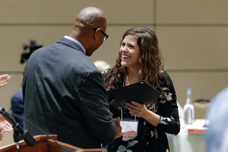Sally Morris Cote, H.E.A.L., receiving her Riley Fellow certificate from Juan Johnson