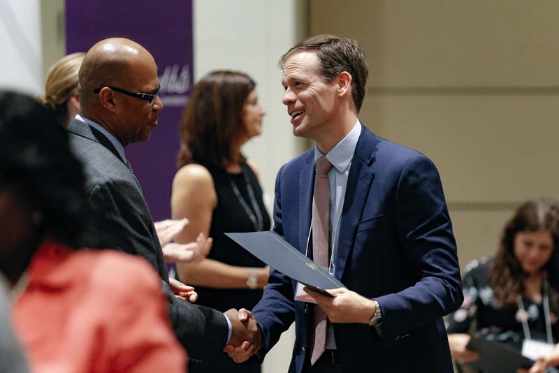 Ansel Sanders, H.E.A.L., receiving his Riley Fellow certificate from Juan Johnson