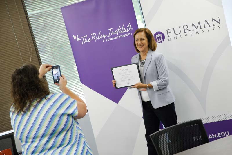 Della Watkins, Project Power Play, posing with her Riley Fellow certificate