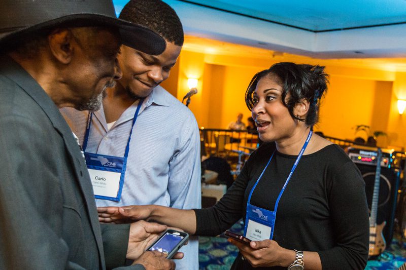 Carlo and Nika White talking with Mac Arnold