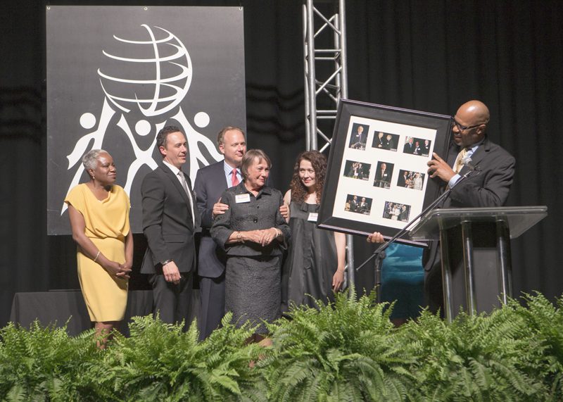 Juan Johnson presenting framed set of photos of Calder from each of the previous Diversity Awards Dinners.