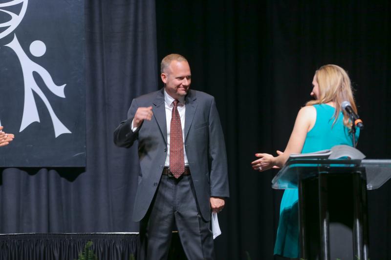 Gabrielle welcoming Calder Ehrmann's son, Jacob Ehrmann, to the stage