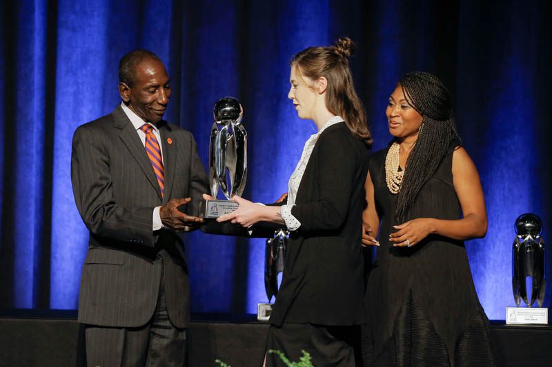 Lee Gill, Chief Inclusion Officer at Clemson University, presenting the Outstanding College Student award to Adahlia Nix