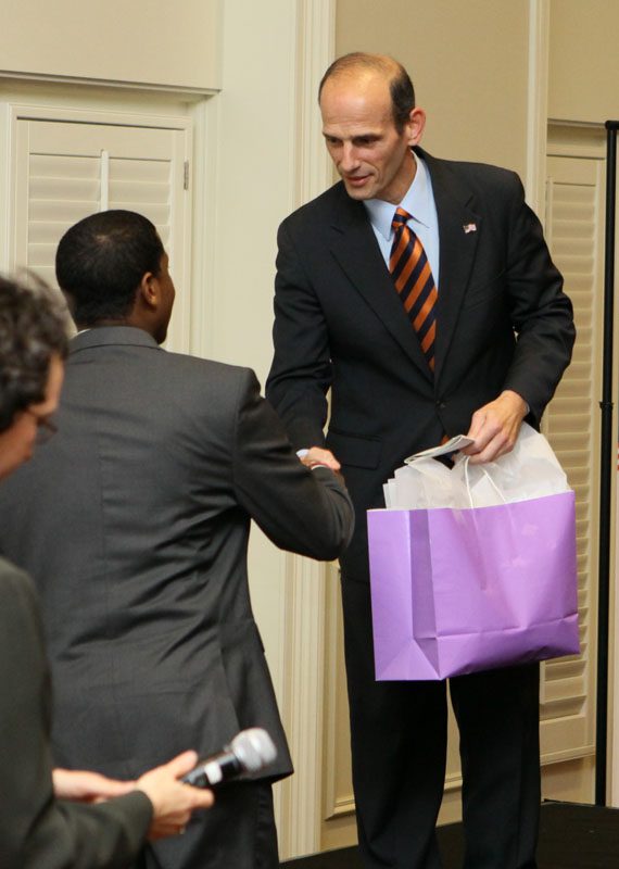 Advance Team member Jason Terrell presenting John Baldacci with a gift