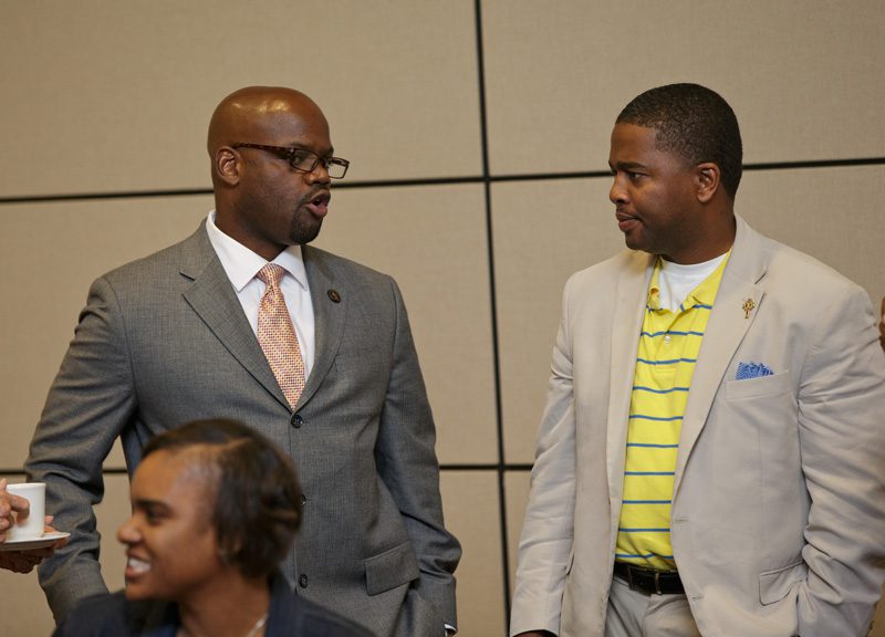 Montrio Belton conversing with a guest