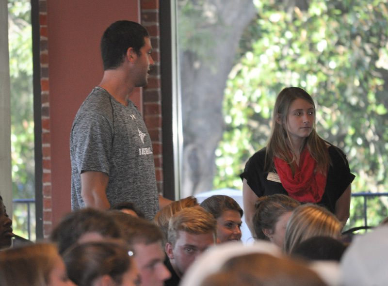 A student poses a question for the panelists