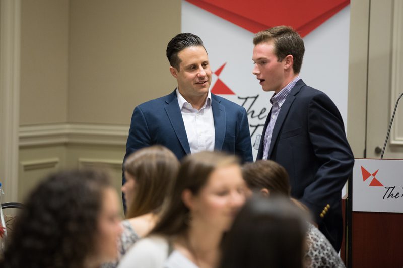 Nick Galasso speaking with a student