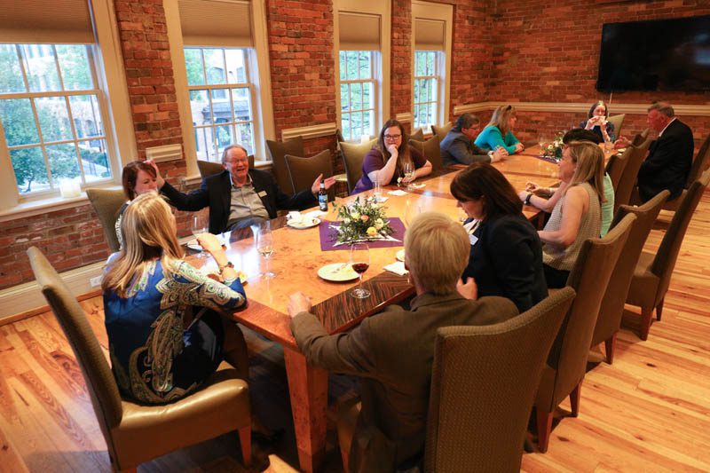 Gathering around the table for dinner and captivating conversation