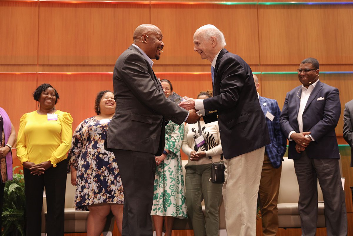 Sec. Dick Riley presents the OneSouthCarolina Partners in Progress award to Tony Thomas, community engagement coordinator of Northside Development Group.