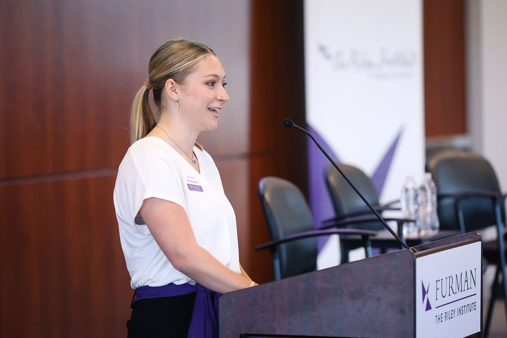 Anna Hicks speaks at the podium