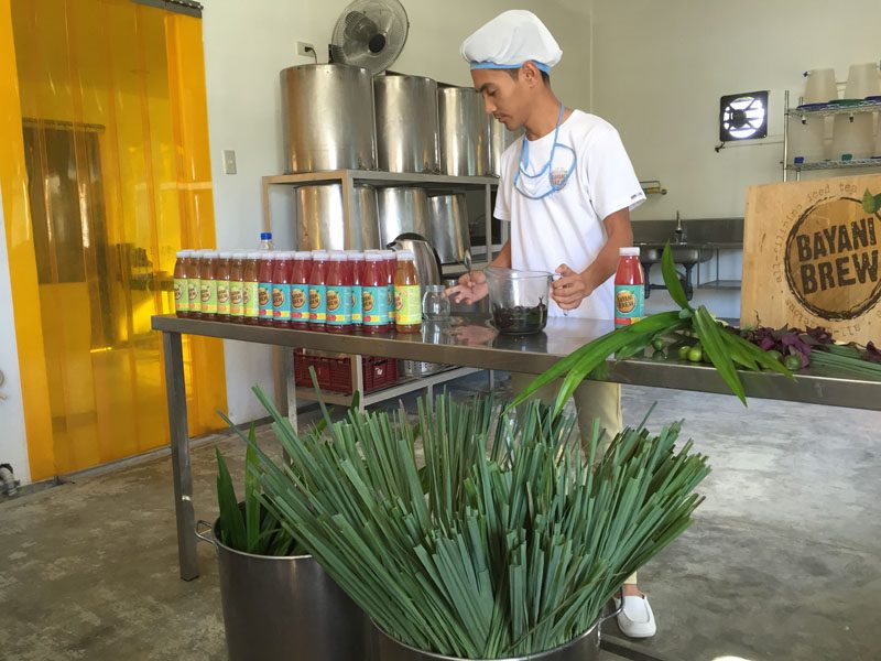 A social entrepreneur from Gawad Kalinga shows VOF delegates how to make Bayani Brew