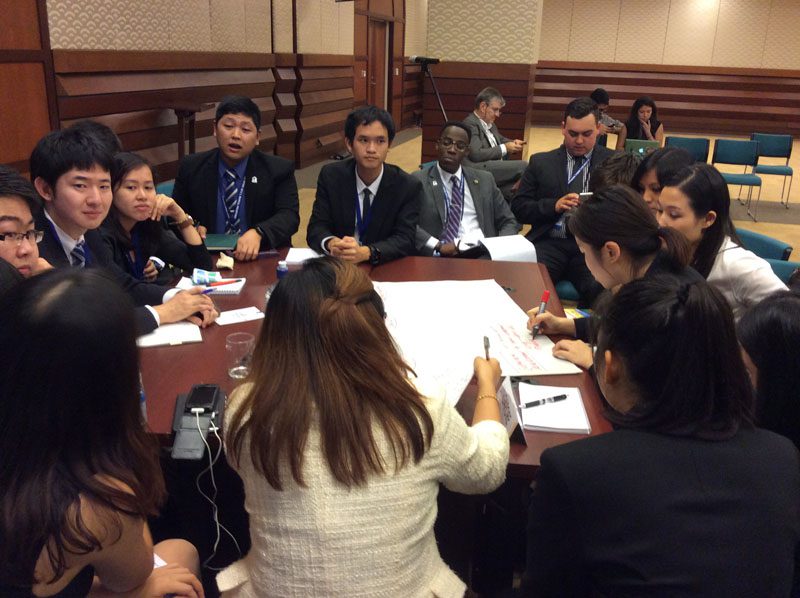 U.S. delegate Jonathan Kubakundimana discusses economic issues in the different member economies with other VOF delegates