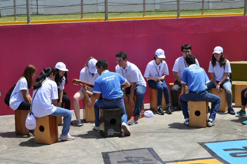 APEC delegates join in to learn how to play the traditional drums