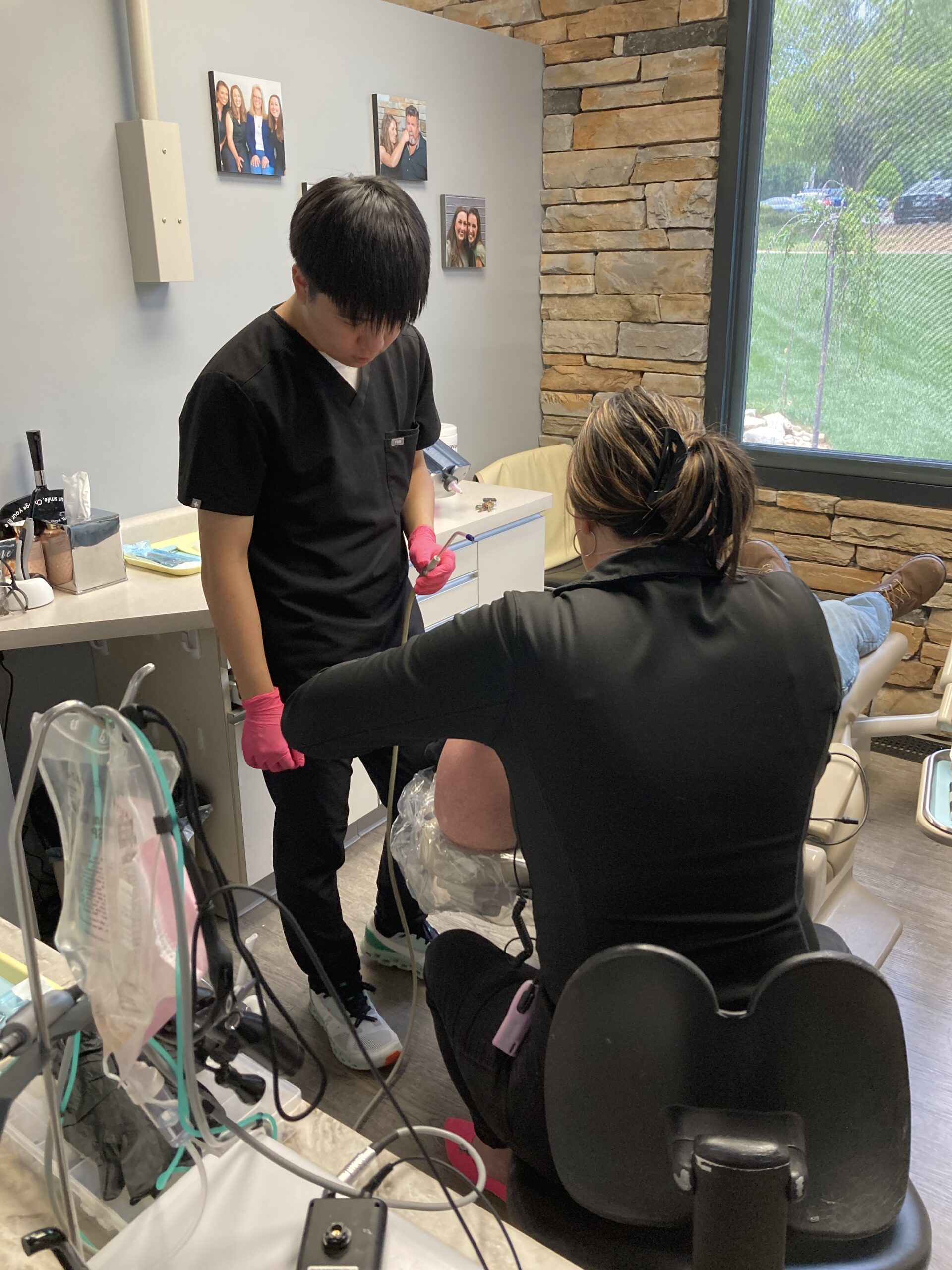 Student observes a dentist working on a patient.