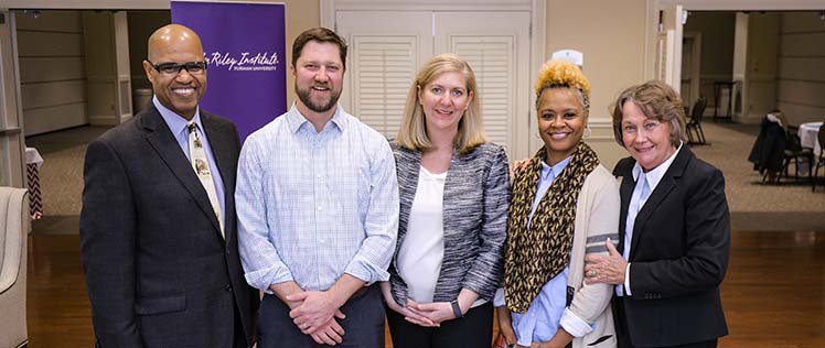 A group shot of spring 2019 scholarship recipients standing next to Juan Johnson